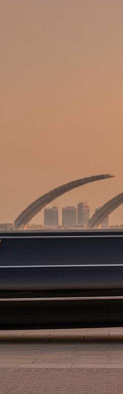 Executive stepping out of a luxury chauffeur car at a Dubai business district