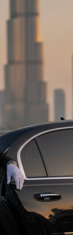 Anniversary chauffeur service in Dubai with luxury car at sunset